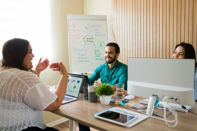 Happy diverse marketing team discussing their business strategy during a productive meeting