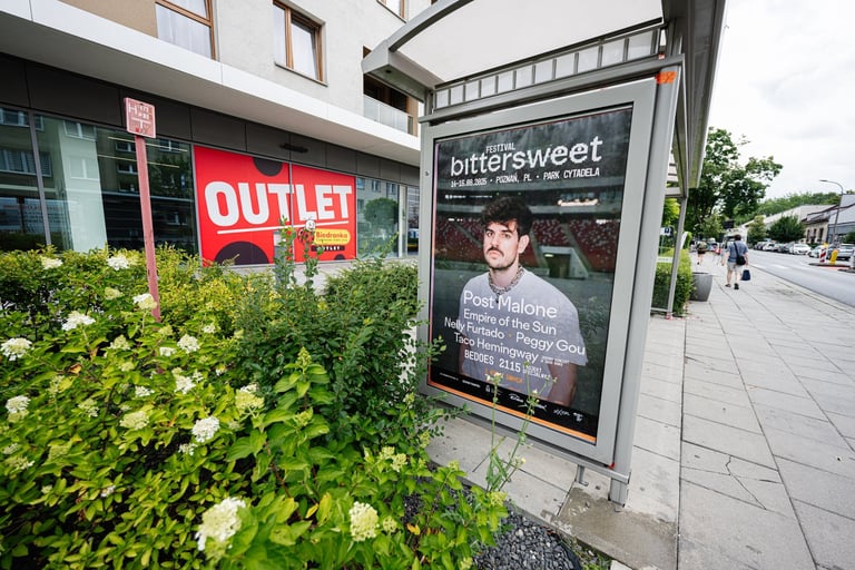 Festival poster displayed at bus stop in urban area