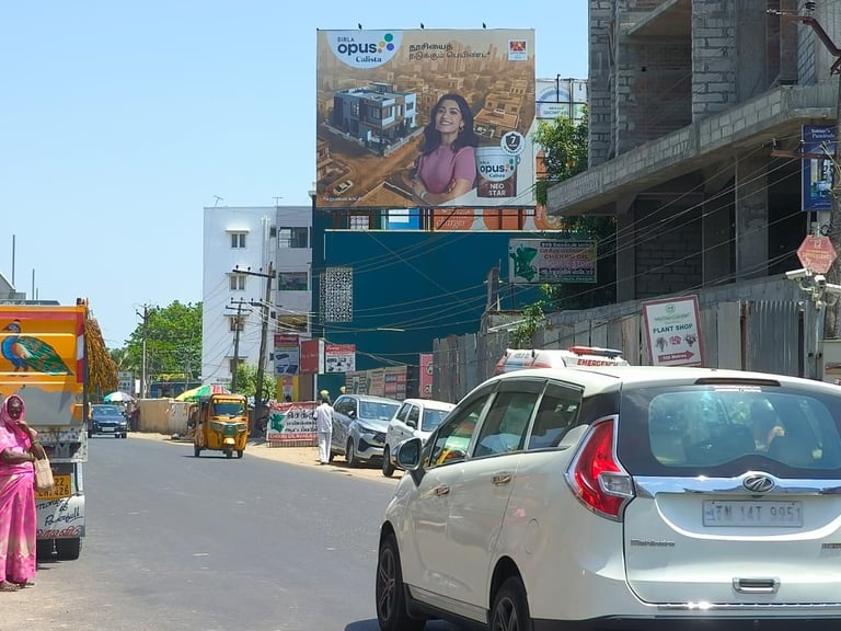 Urban street scene with cars, commercial buildings, and large billboards advertising products