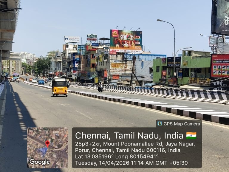 Chennai street with busy urban road, colorful buildings, billboards, and traffic