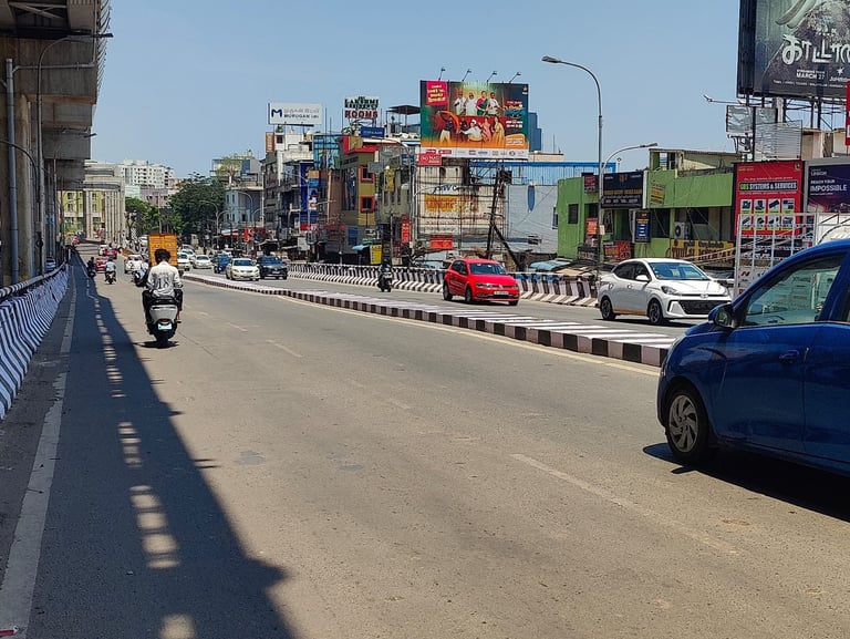 Busy city street with traffic, colorful commercial buildings, shops and billboards