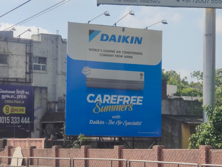 Large blue Daikin air conditioning billboard advertisement featuring Carefree Summers branding positioned on a brick structure with cityscape background